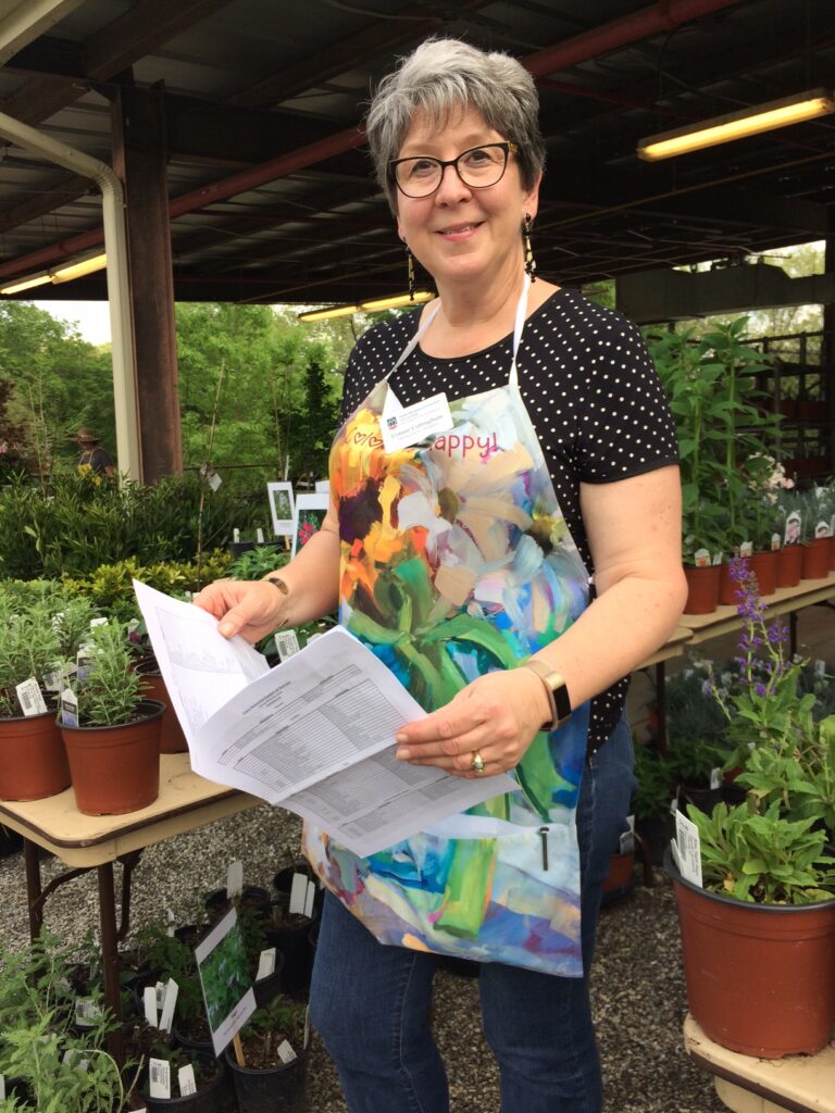 Connie Cottingham working at a plant sale.